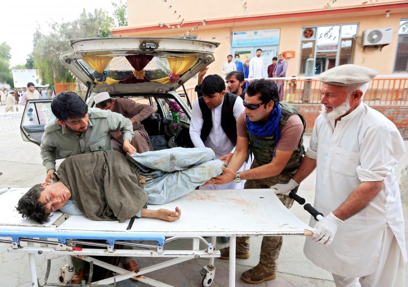 Men carry an injured person to a hospital after a bomb blast at a mosque, in Jalalabad, Afghanistan October 18, 2019. REUTERS
