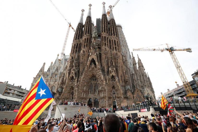 Catalan demonstrators chant slogans in front of La Sagrada Familia basilica during Catalonia`s general strike in Barcelona, Spain, Oct 18, 2019. REUTERS