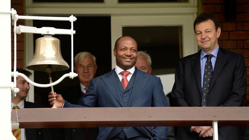Ex-West Indies cricket captain Brian Lara rings the bell before play on the second day of the first cricket test match between England and the West Indies at Lord`s Cricket Ground in London May 18, 2012. REUTERS/FILE PHOTO