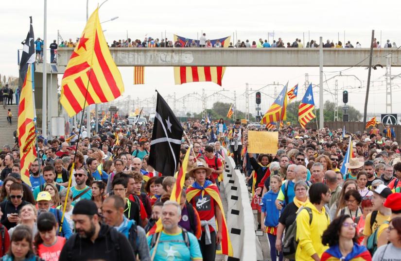 Catalan demonstrators wearing and waving Esteladas (Catalan separatist flags) chant slogans as they march during Catalonia`s general strike in El Masnou, Spain, Oct 18, 2019. REUTERS