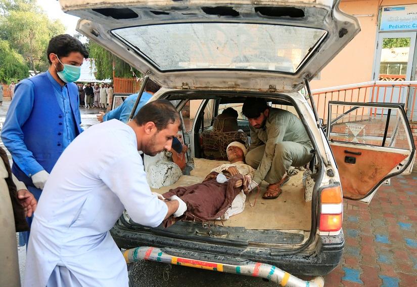 Men carry an injured person to a hospital after a bomb blast at a mosque, in Jalalabad, Afghanistan Oct 18, 2019.REUTERS