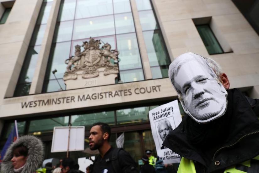 Demonstrators hold banners during a protest outside of Westminster Magistrates Court, where a case management hearing in the U.S. extradition case of WikiLeaks founder Julian Assange is held, in London, Britain, Oct 21, 2019. REUTERS