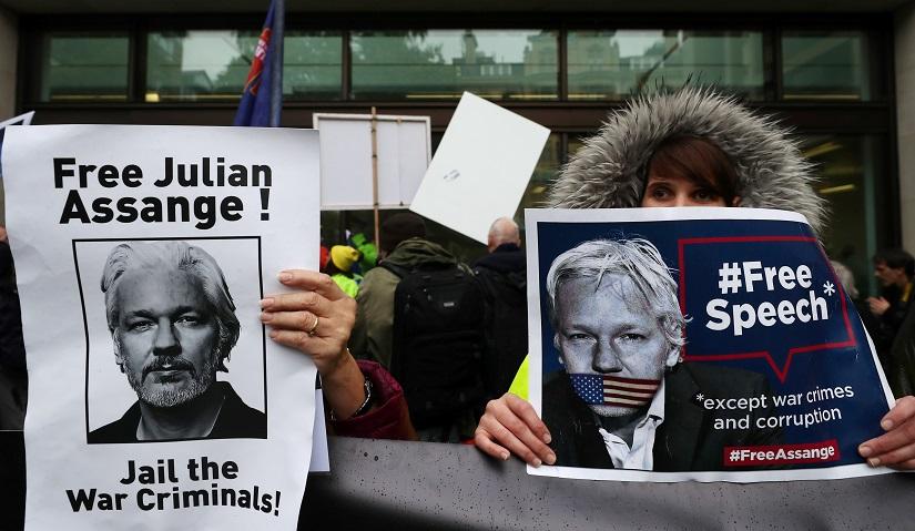 Demonstrators hold placards during a protest outside of Westminster Magistrates Court, where a case management hearing in the U.S. extradition case of WikiLeaks founder Julian Assange is held, in London, Britain, Oct 21, 2019. REUTERS