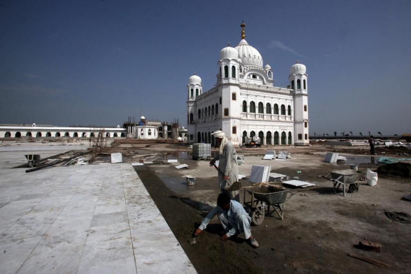 FILE PHOTO: Laborers work at the sites of the Gurdwara Darbar Sahib, which will be open this year for Indian Sikh pilgrims, in Kartarpur, Pakistan Sept 16, 2019. REUTERS