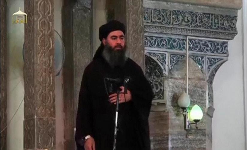 FILE PHOTO: A man purported to be the reclusive leader of the militant Islamic State Abu Bakr al-Baghdadi has made what would be his first public appearance at a mosque in the centre of Iraq`s second city, Mosul, according to a video recording posted on the Internet on July 5, 2014, in this still image taken from video. Social Media Website via Reuters TV