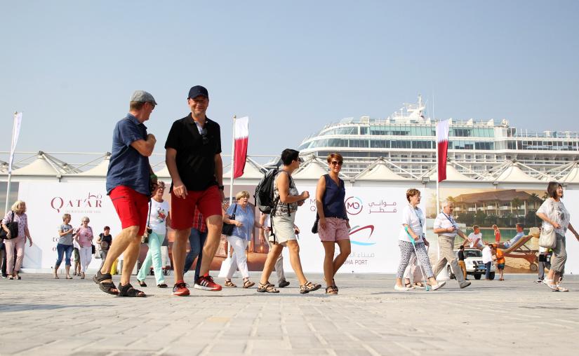 FILE PHOTO: Foreign tourists who arrived on a cruise ship Mein Schiff 5, walk at Doha Port in Doha, Qatar, October 22, 2019. REUTERS