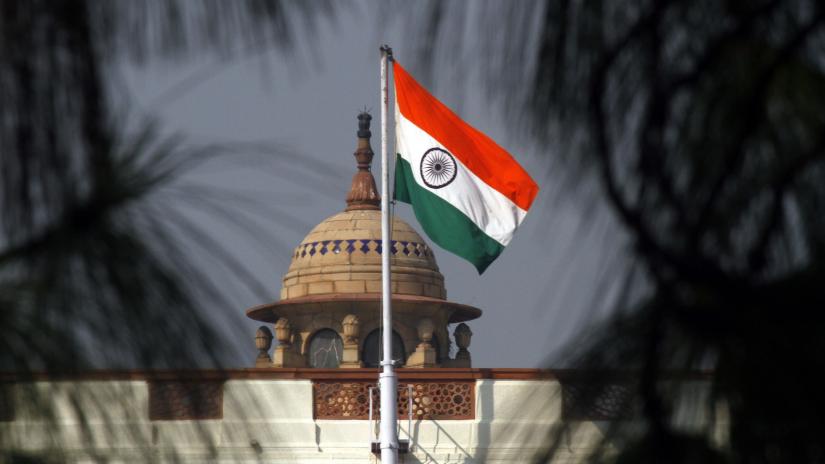 The Indian national flag flutters on top of the parliament building in New Delhi December 1, 2010. REUTERS/File Photo