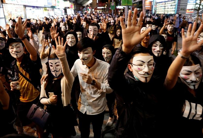 FILE PHOTO: Protesters wearing Guy Fawkes masks attend an anti-government demonstration in Hong Kong, China, Nov 5, 2019. REUTERS