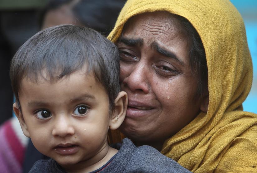 A Rohingya Muslim woman cries as she holds her daughter after they were detained by Border Security Force (BSF) soldiers while crossing the India-Bangladesh border from Bangladesh, at Raimura village on the outskirts of Agartala, January 22, 2019. REUTERS