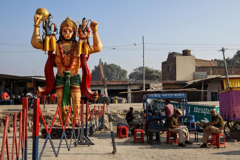 A statue of Hindu monkey god Hanuman is seen next to security barricade as police officers take a break after Supreme Court`s verdict on a disputed religious site, in Ayodhya, India, Nov 11, 2019. REUTERS