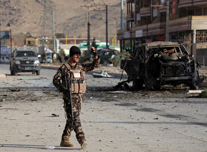A member of the Afghan security forces keeps watch at the site of a suicide blast in Kabul, Afghanistan Nov 13, 2019.REUTERS