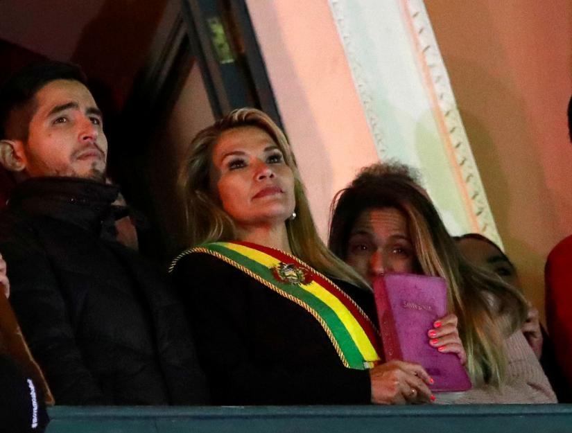 Bolivian Senator Jeanine Anez gestures after she declared herself as Interim President of Bolivia, at the balcony of the Presidential Palace, in La Paz, Bolivia November 12, 2019. REUTERS