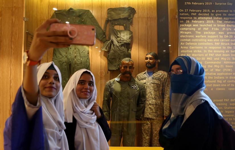 Students take selfies with a mannequin, representing Indian pilot Wing Commander Abhinandan Varthaman, after his Mig-21 fighter aircraft was shot down by Pakistan Air Force on February 27, 2019, at a gallery ‘Operation Swift Retort’ at the Pakistan Air Force (PAF) Museum in Karachi, Pakistan November 13, 2019. REUTERS
