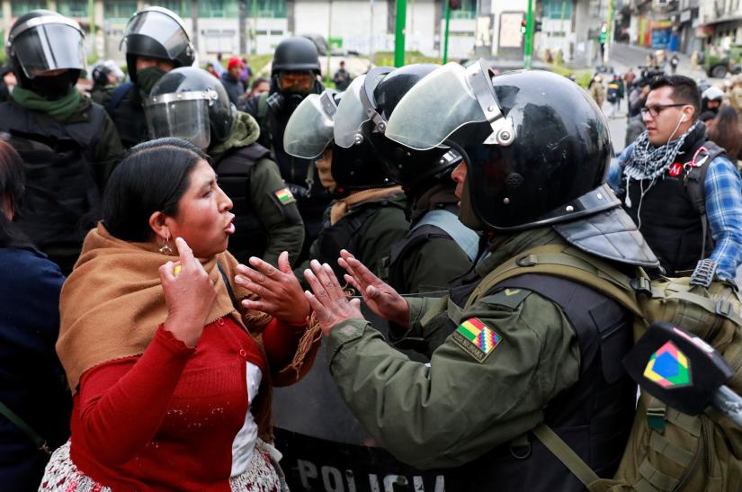   A woman argues with a member of the security forces during clashes between members of the security forces and supporters of former Bolivian President Evo Morales in La Paz, Bolivia November 13, 2019. REUTERS