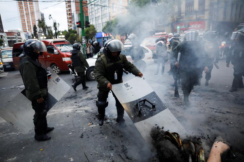 A member of the security forces holds a shield during clashes between supporters of former Bolivian President Evo Morales and members of the security forces, in La Paz, Bolivia November 13, 2019. REUTERS