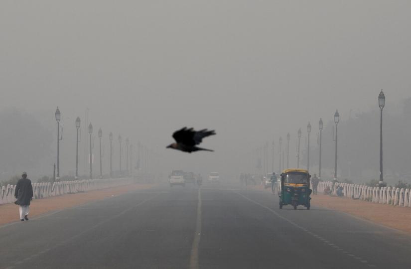 A bird flies amidst smog near India`s Presidential Palace in New Delhi, India, November 13, 2019. REUTERS