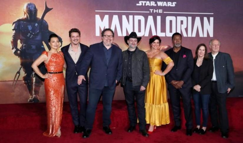 FILE PHOTO: Creator Jon Favreau (3rd L), President of Lucasfilm Kathleen Kennedy (2nd R), executive producer Dave Filoni (C) pose with cast members (L-R) Ming-Na Wen, Pedro Pascal, Gina Carano, Carl Weathers and Werner Herzog at the premiere for the television series `The Mandalorian` in Los Angeles, California, U.S., November 13, 2019. REUTERS