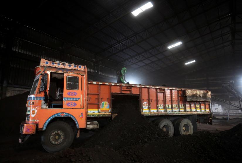  A worker shovels coal in a supply truck at a yard on the outskirts of Ahmedabad, India, October 25, 2018. REUTERS