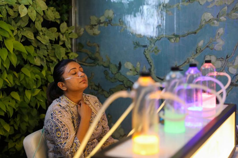 Nishika Waghela (33) breathes in oxygen mixed with aromatherapy via a nasal cannula, at an oxygen bar in New Delhi, India, November 15, 2019. REUTERS