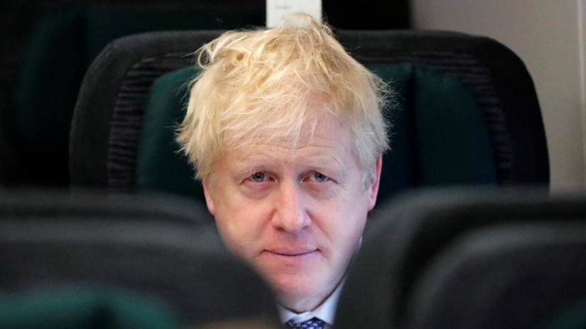 Britain`s Prime Minister Boris Johnson looks up as he sits on a train, on his way to an election campaign event near Castle Cary, Britain November 14, 2019. Frank Augstein/Pool via REUTERS