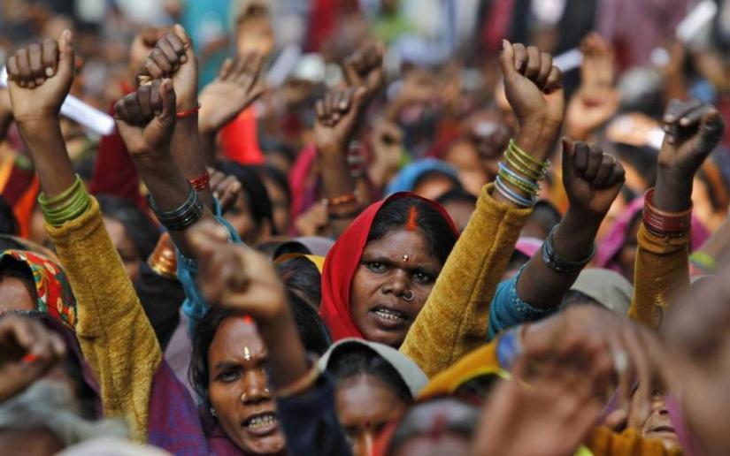 FILE PHOTO: Forest dwellers raise their hands and shout slogans during a rally in New Delhi Dec 15, 2011. REUTERS