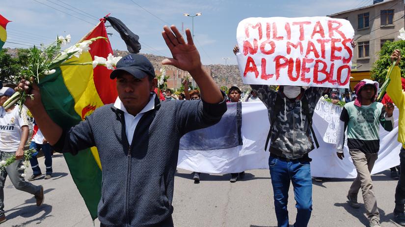 Supporters of former Bolivia's President Evo Morales participate in a march in Cochabamba, Bolivia, Novemver 16, 2019. The sign reads 'Military doesn't kill people'. REUTERS