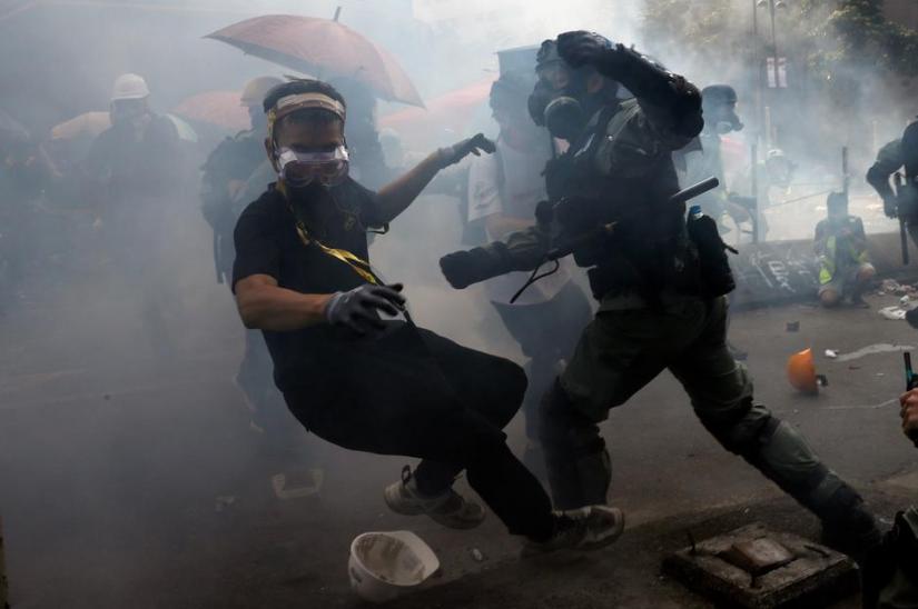 A protester is detained by riot police while attempting to leave the campus of Hong Kong Polytechnic University (PolyU) during clashes with police in Hong Kong, China Nov 18, 2019. REUTERS