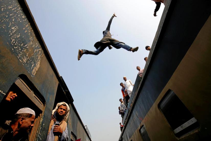 A Man jumping from one train to another in Dhaka REUTERS/File PHoto