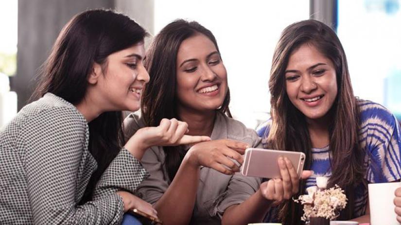 There cannot be any jiggery-pokery in a digital system. Photo shows three girls passing fun time using a smartphone FACEBOOK/Grameenphone