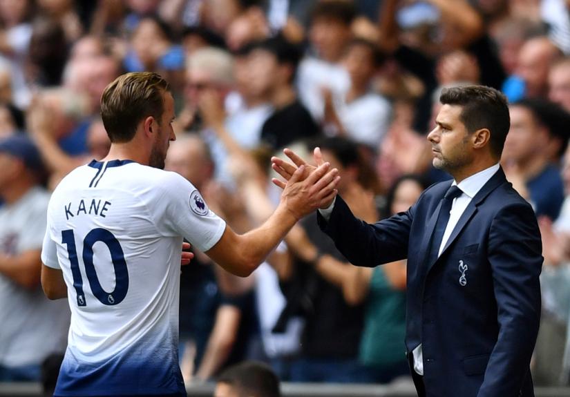 File Photo: August 18, 2018 Tottenham`s Harry Kane shakes hands with manager Mauricio Pochettino after being substituted REUTERS