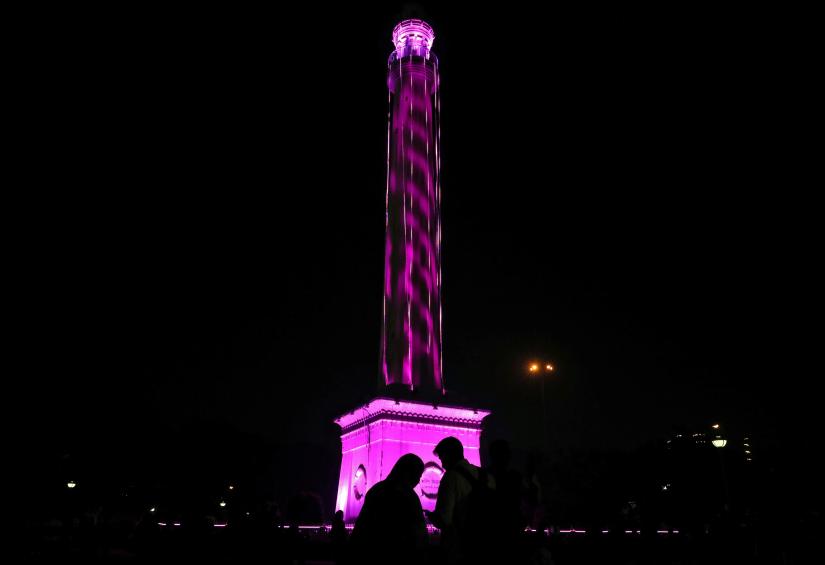 An under-construction high-rise residential tower is illuminated in pink on the eve of the first day-night test cricket match between India and Bangladesh using pink ball, in Kolkata, India, November 21, 2019. REUTERS