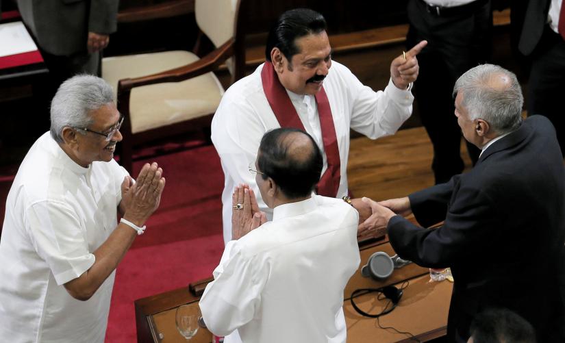 Sri Lanka`s President Gotabaya Rajapaksa and his brother and former leader Mahinda Rajapaksa, who was appointed as the new Prime Minister, greet former Prime Minister Ranil Wickeremesinghe and former President Maithripala Sirisena during the swearing in ceremony in Colombo, Sri Lanka November 21, 2019. REUTERS