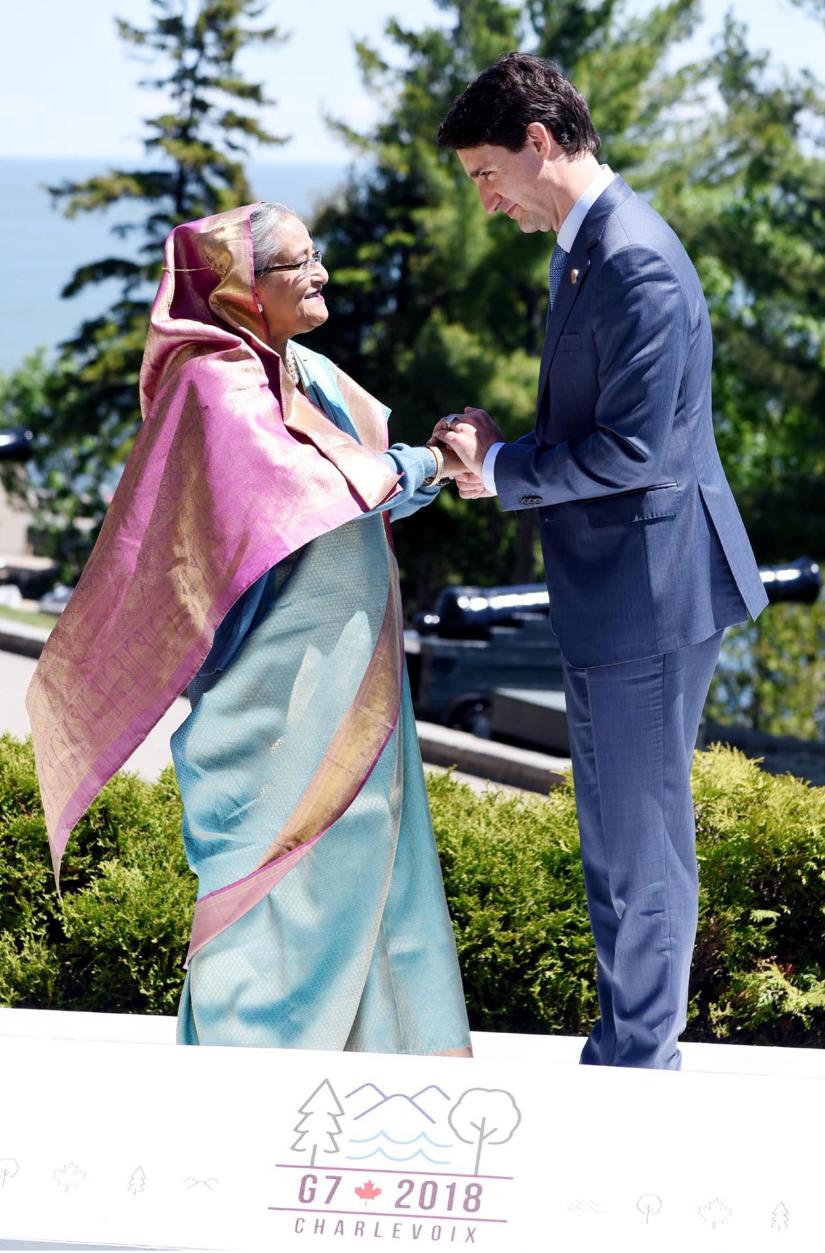 Canada`s Prime Minister Justin Trudeau shakes hands with Bangladesh`s Prime Minister Sheikh Hasina as he welcomes representatives from outreach countries and international organizations during the G7 leaders summit in La Malbaie, Que., on Saturday, June 9, 2018. PID/File Photo