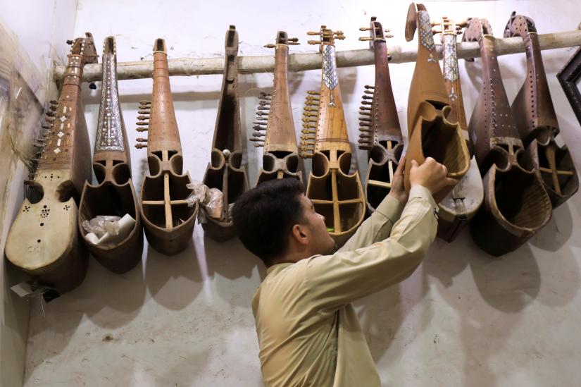 FILE PHOTO: A craftsman arranges unfinished Rabab, traditional music instruments, at a workshop in Peshawar, Pakistan August 20, 2019. REUTERS