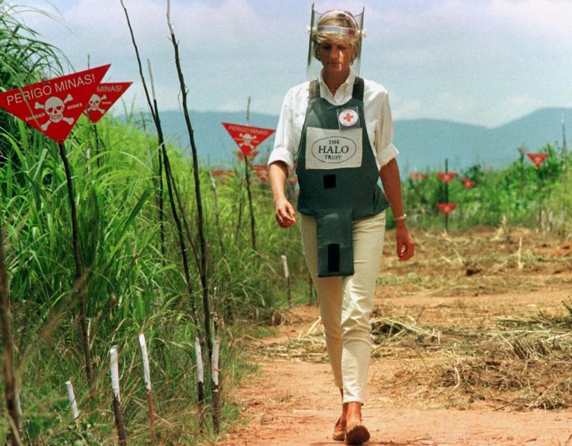 Diana, Princess of Wales is seen in this January 15 1997 file picture walking in one of the safety corridors of the land mine fields of Huambo, Angola during her visit to help a Red Cross campaign to outlaw landmines worldwide. REUTERS