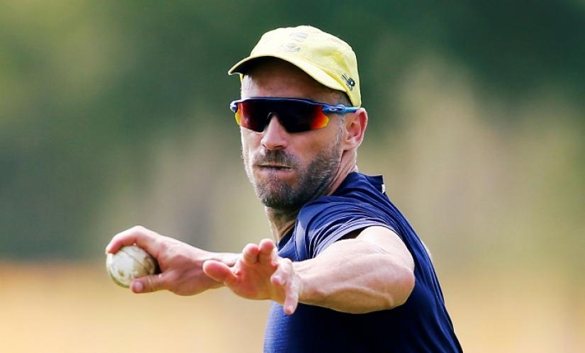FILE PHOTO: South Africa`s captain Faf du Plessis throws a ball during a practice session ahead of their first One Day International (ODI) cricket match against Sri Lanka. REUTERS