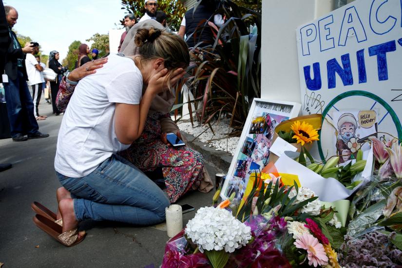 A woman reacts at a make shift memorial outside the Al-Noor mosque in Christchurch, New Zealand March 23, 2019. REUTERS