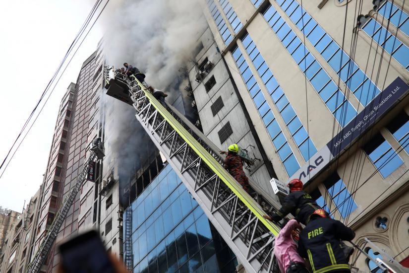 People are seen being rescued as fire broke out at multi-storey FR Tower in Dhaka, Bangladesh, March 28, 2019. REUTERS