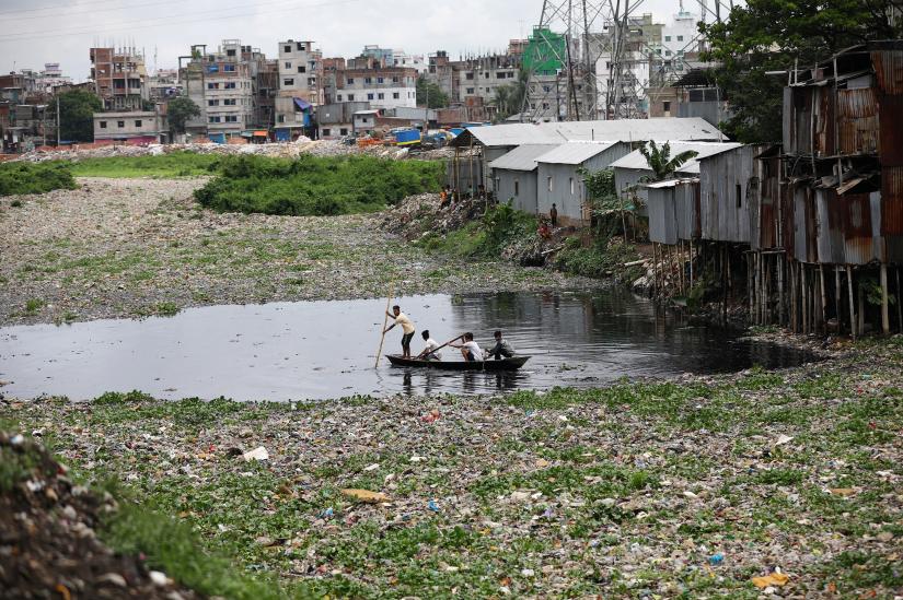 People cross the heavily polluted Buriganga river by boat in Dhaka, Bangladesh, July 2, 2019. REUTERS