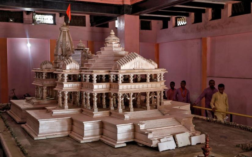 FILE PHOTO: Devotees look at a model of the proposed Ram temple that Hindu groups want to build at a disputed religious site in Ayodhya, Oct 22, 2019. REUTERS