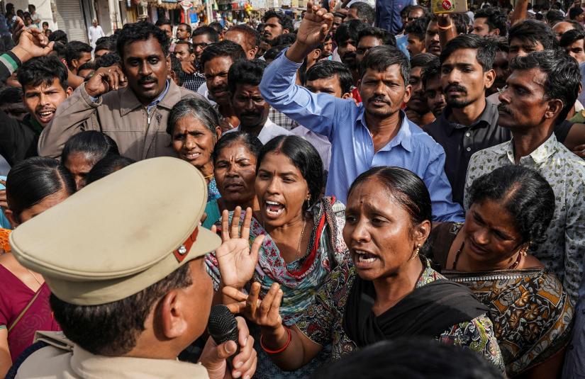 Demonstrators argue with a police officer during a protest against the alleged rape and murder of a 27-year-old woman in Shadnagar, on the outskirts of Hyderabad, India, November 30, 2019. REUTERS