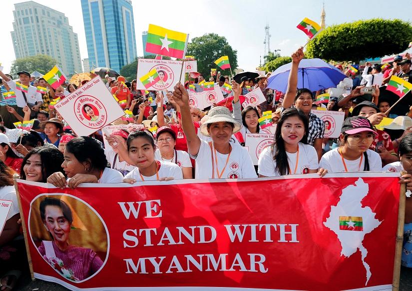People gather to rally in support of Myanmar State Counsellor Aung San Suu Kyi before she heads off to the International Court of Justice (ICJ), in Yangon, Myanmar Dec 1, 2019. REUTERS