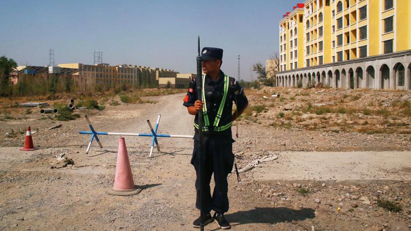 A Chinese police officer takes his position by the road near what is officially called a vocational education centre in Yining in Xinjiang Uighur Autonomous Region, China September 4, 2018. REUTERS