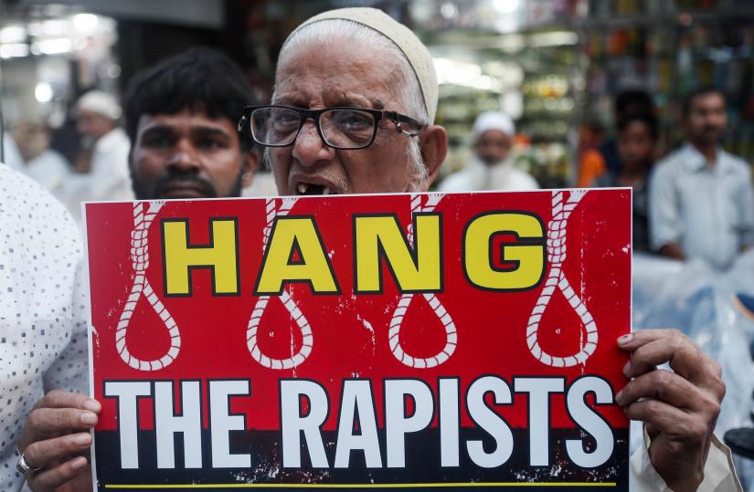 A man holds a placard and shouts slogans during a protest against the alleged rape and murder of a 27-year-old woman on the outskirts of Hyderabad, in Mumbai, India, December 3, 2019. REUTERS