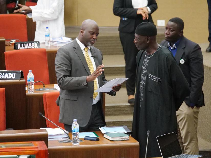 The Gambia Justice Minister Abubacarr Tambadou discusses the bill with a member of Parliament at the national assembly in Banjul, Gambia December 2, 2019. REUTERS/File Photo