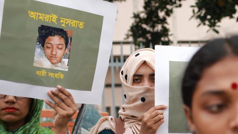 Women hold placards and photographs of schoolgirl Nusrat Jahan Rafi at a protest in Dhaka on Apr 12, 2019, following her murder by being set on fire after she had reported a sexual assault. SAZZAD HOSSAIN/File Photo