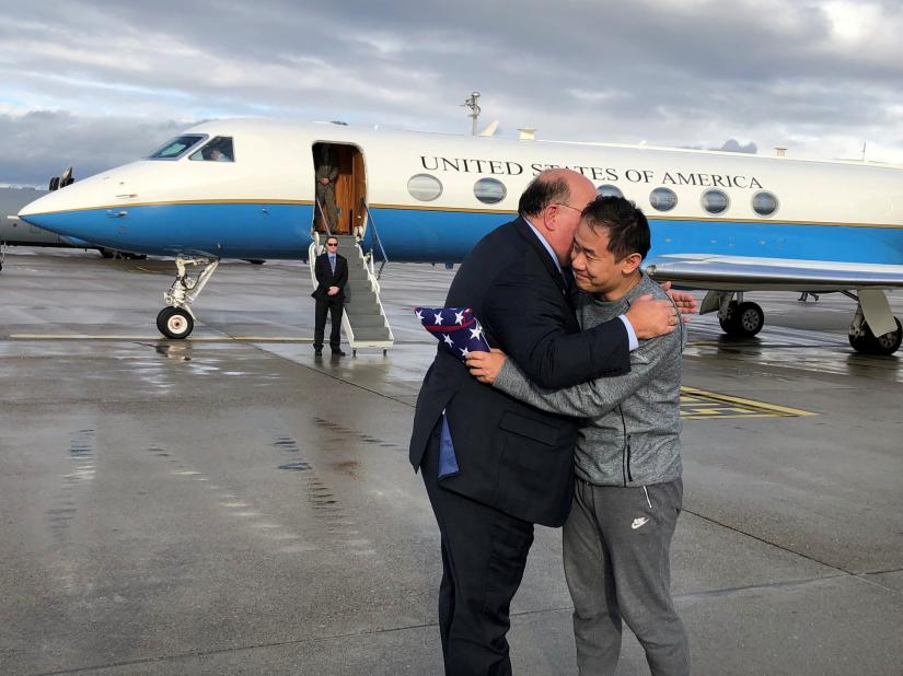 U.S. Ambassador to Switzerland Edward McMullen greets Xiyue Wang in Zurich, Switzerland December 7, 2019. U.S. Embassy in Switzerland/Handout via REUTERS