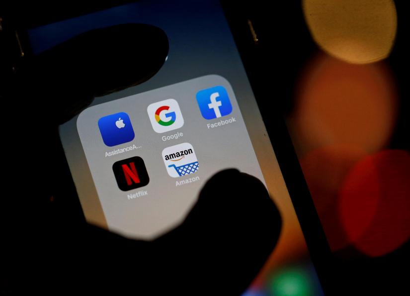 The logos of mobile apps, Google, Amazon, Facebook, Apple and Netflix, are displayed on a screen in this illustration picture taken December 3, 2019. REUTERS/File Photo