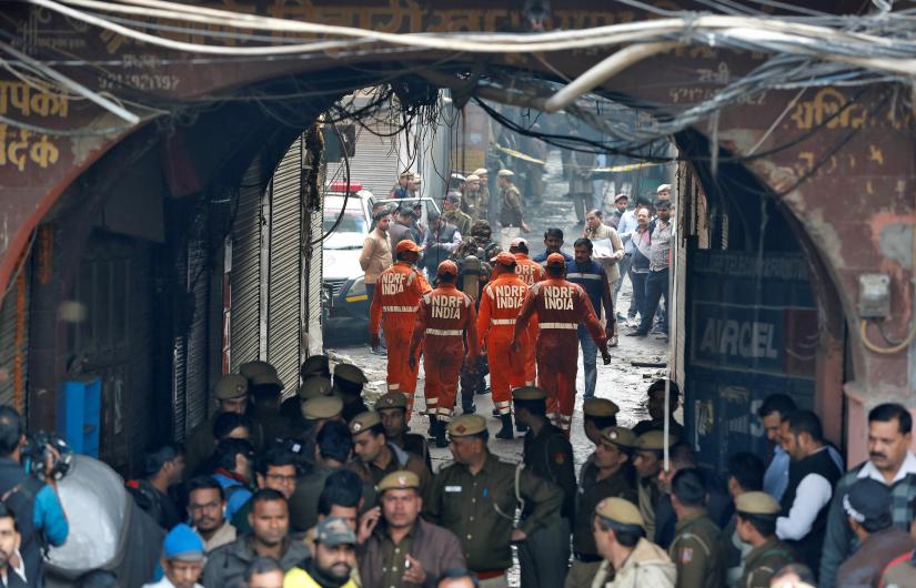 Members of India`s National Disaster Response Force (NDRF) head towards the site of a fire that swept through a factory where laborers were sleeping, in New Delhi, India December 8, 2019. REUTERS