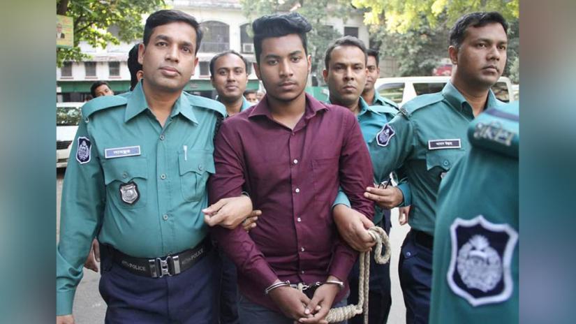Police officials take Abdur Rahman Saikat to remand from the court area in Dhaka on Sunday (Dec 8). Focus Bangla